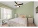 Bright bedroom with a quaint style, white wicker furniture and green walls at 168 Pond Rd, Mount Dora, FL 32757