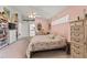 Bedroom featuring a floral bedspread, vaulted ceiling, and an adjoining doorway at 168 Pond Rd, Mount Dora, FL 32757