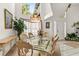 Dining room with high ceilings, large windows, and elegant glass table at 168 Pond Rd, Mount Dora, FL 32757