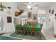 The dining room with large windows, a green rug and a stag's head hanging on the wall at 168 Pond Rd, Mount Dora, FL 32757