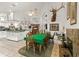 Open dining room with stone fireplace, stag's head, and view to the kitchen at 168 Pond Rd, Mount Dora, FL 32757