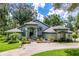 Well-maintained home with a manicured lawn, lush landscaping, and a welcoming driveway leading to the entrance at 168 Pond Rd, Mount Dora, FL 32757