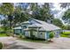 Gorgeous home with a spacious driveway, lush greenery, and scenic water views at 168 Pond Rd, Mount Dora, FL 32757