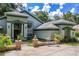 Charming front exterior featuring manicured landscaping, decorative brick accents, and a well-maintained lawn at 168 Pond Rd, Mount Dora, FL 32757