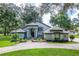 Charming home with landscaped front yard, circular driveway and lovely architectural details at 168 Pond Rd, Mount Dora, FL 32757