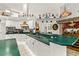 Spacious kitchen featuring white cabinets, green counters, and stainless steel appliances at 168 Pond Rd, Mount Dora, FL 32757
