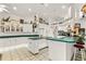Bright kitchen features white cabinetry, green countertops, and an island at 168 Pond Rd, Mount Dora, FL 32757