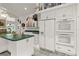 Kitchen featuring white cabinets, green counters, and modern appliances at 168 Pond Rd, Mount Dora, FL 32757