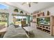Inviting living room with neutral tones, entertainment center and large window view to backyard at 168 Pond Rd, Mount Dora, FL 32757