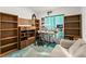 Bright office space with built in bookshelves and an adjustable work table at 168 Pond Rd, Mount Dora, FL 32757