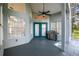 Spacious enclosed porch with grill, fan, and a view of the yard at 168 Pond Rd, Mount Dora, FL 32757