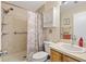 Neutral bathroom featuring step-in shower and wood vanity at 16938 Se 94Th Sunnybrook Cir, The Villages, FL 32162