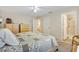Spacious bedroom with carpet and comfortable bed near the bathroom at 16938 Se 94Th Sunnybrook Cir, The Villages, FL 32162