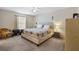 Spacious bedroom with carpet, ceiling fan and comfortable bed at 16938 Se 94Th Sunnybrook Cir, The Villages, FL 32162