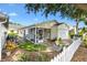 Home with a screened porch and white picket fence offers a cozy outdoor living space at 16938 Se 94Th Sunnybrook Cir, The Villages, FL 32162