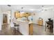 Eat-in kitchen with breakfast bar, white appliances, and neutral countertops at 16938 Se 94Th Sunnybrook Cir, The Villages, FL 32162