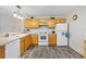 Eat-in kitchen with white appliances, wood cabinets, and white countertops at 16938 Se 94Th Sunnybrook Cir, The Villages, FL 32162