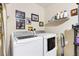 Laundry area equipped with modern washer and dryer, offering efficiency and convenience for household chores at 16938 Se 94Th Sunnybrook Cir, The Villages, FL 32162