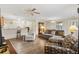Open concept living room with new flooring and easy access to kitchen and dining area at 16938 Se 94Th Sunnybrook Cir, The Villages, FL 32162