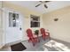 Relaxing covered porch featuring comfortable seating and overhead fan at 16938 Se 94Th Sunnybrook Cir, The Villages, FL 32162