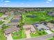Aerial view of single-story home on a landscaped lot overlooking a golf course with pond in a neighborhood setting at 17599 Se 121St Cir, Summerfield, FL 34491