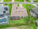 An aerial view shows the home and its surroundings, with a meticulously maintained lawn and screened in patio at 17599 Se 121St Cir, Summerfield, FL 34491