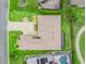 An aerial view showcases the home's layout, manicured landscaping, and inviting screened-in patio at 17599 Se 121St Cir, Summerfield, FL 34491