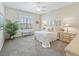 Comfortable bedroom with carpet, a large window, and coordinated furniture, creating a peaceful retreat at 17599 Se 121St Cir, Summerfield, FL 34491