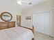 Bedroom with wood furniture, closet and view into bathroom, with ceiling fan at 17599 Se 121St Cir, Summerfield, FL 34491