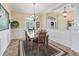 Bright dining area with neutral walls, and wainscotting features updated light fixture and ceramic tile floors at 17599 Se 121St Cir, Summerfield, FL 34491