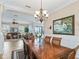 This formal dining area connects to the living room and features a tray ceiling and hardwood table at 17599 Se 121St Cir, Summerfield, FL 34491