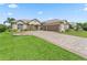 Charming single-story home showcasing a paver driveway, shutters, and manicured landscaping at 17599 Se 121St Cir, Summerfield, FL 34491