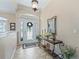 Inviting foyer with decorative table, mirror, and tile flooring at 17599 Se 121St Cir, Summerfield, FL 34491