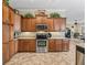 Traditional kitchen featuring custom wood cabinets, granite countertops, stainless steel appliances, and decorative accents at 17599 Se 121St Cir, Summerfield, FL 34491