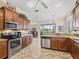 Bright kitchen featuring stainless steel appliances, granite countertops, and a view of the backyard and golf course at 17599 Se 121St Cir, Summerfield, FL 34491