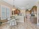 Open kitchen and breakfast nook with wooden cabinets, granite countertops, and seating for four around a glass table at 17599 Se 121St Cir, Summerfield, FL 34491