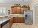 Bright eat-in kitchen has granite countertops, stainless steel appliances, wood cabinets, tile backsplash and floors at 17599 Se 121St Cir, Summerfield, FL 34491