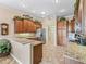 Open concept kitchen with granite countertops, stainless steel appliances, and wood cabinets with under-cabinet lighting at 17599 Se 121St Cir, Summerfield, FL 34491