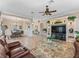 Open-concept living room is adjacent to the dining room, with ceramic tile floors and neutral color scheme at 17599 Se 121St Cir, Summerfield, FL 34491
