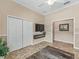 Spacious living room with large closet, TV and view into adjoining room at 17599 Se 121St Cir, Summerfield, FL 34491