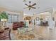 This neutral living room features plantation shutters on the windows and connects to the kitchen and dining room at 17599 Se 121St Cir, Summerfield, FL 34491