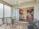 Outdoor patio with seating and view into kitchen and dining area via sliding doors at 17599 Se 121St Cir, Summerfield, FL 34491