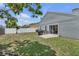 An expansive backyard featuring a grassy area and patio space, with a view of the rear exterior of the home at 1808 Westpointe Cir, Orlando, FL 32835