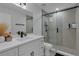 Modern bathroom featuring a glass-enclosed shower, and updated vanity with a stone countertop and black hardware at 1808 Westpointe Cir, Orlando, FL 32835