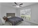 Neutral bedroom featuring a full bed, view to the backyard, and a small nightstand at 1808 Westpointe Cir, Orlando, FL 32835