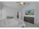 Bright bedroom with a white bed, dresser, and TV, featuring ample natural light at 1808 Westpointe Cir, Orlando, FL 32835
