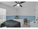 Cozy bedroom with a blue and white color scheme, featuring a comfortable bed and a nightstand at 1808 Westpointe Cir, Orlando, FL 32835