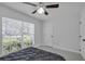 Neutral bedroom featuring a full bed and view to the backyard at 1808 Westpointe Cir, Orlando, FL 32835