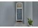 The front entryway features a gray door with transom window and neutral walls at 1808 Westpointe Cir, Orlando, FL 32835