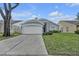 Charming single-story home featuring a two-car garage, arched entryway, and well-maintained landscaping at 1808 Westpointe Cir, Orlando, FL 32835
